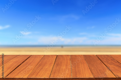 Wood table top on tropical beach and sky background