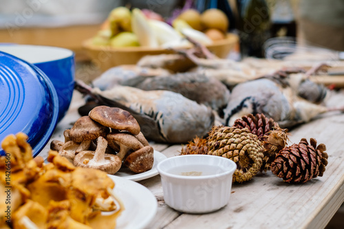Game birds and mushrooms on wooden table