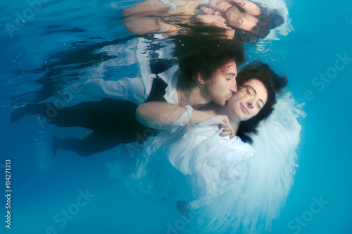 Bride and groom, ring, underwater wedding in pool