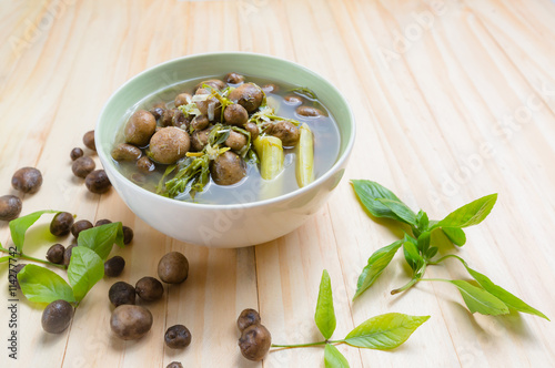 Thai mushroom soup with tamarind leaves. photo