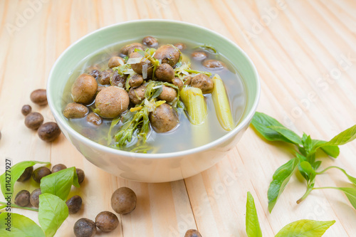 Thai mushroom soup with tamarind leaves. photo