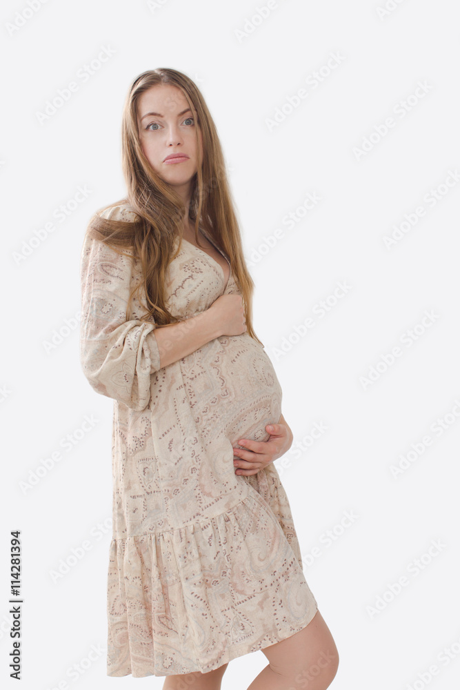 Puzzled, upset pregnant woman holding her belly Puzzled, upset pregnant woman holding her belly