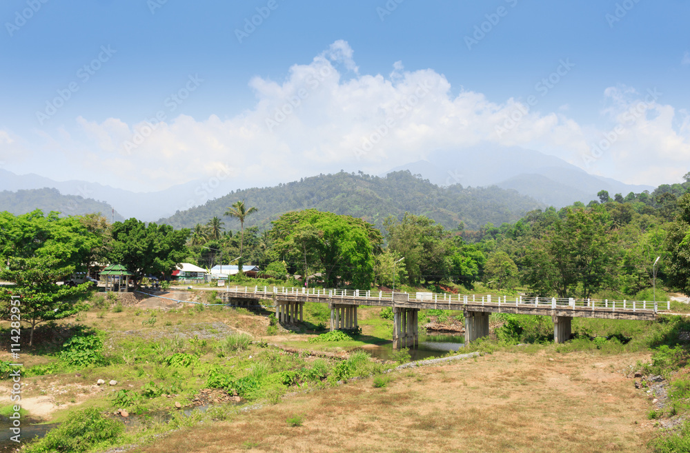 car bridge across the river and mountain views  beautiful skies. in Thailand