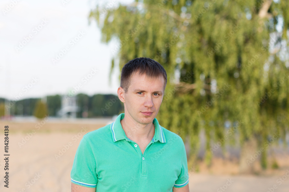 Portrait of beautiful young man on the beach at summer Portrait of beautiful young man on the beach at summer