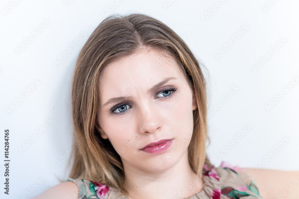 Naklejka premium Depressed, sad woman on white background