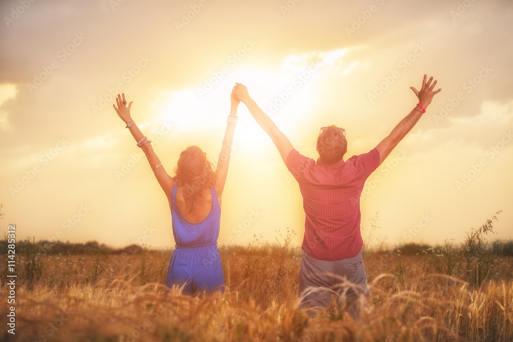 Couple enjoying outdoors in a wheat field. Couple enjoying outdoors in a wheat field.