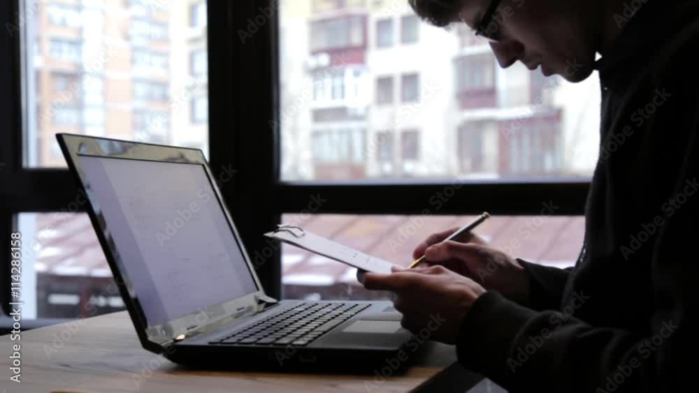 Man Checks Drawings Using a Laptop Man Checks Drawings Using a Laptop