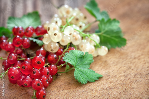 ripe red currant on wooden background with copy space