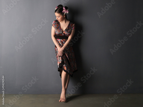 Portrait of attractive  woman with orchids in her hairstyle. photo