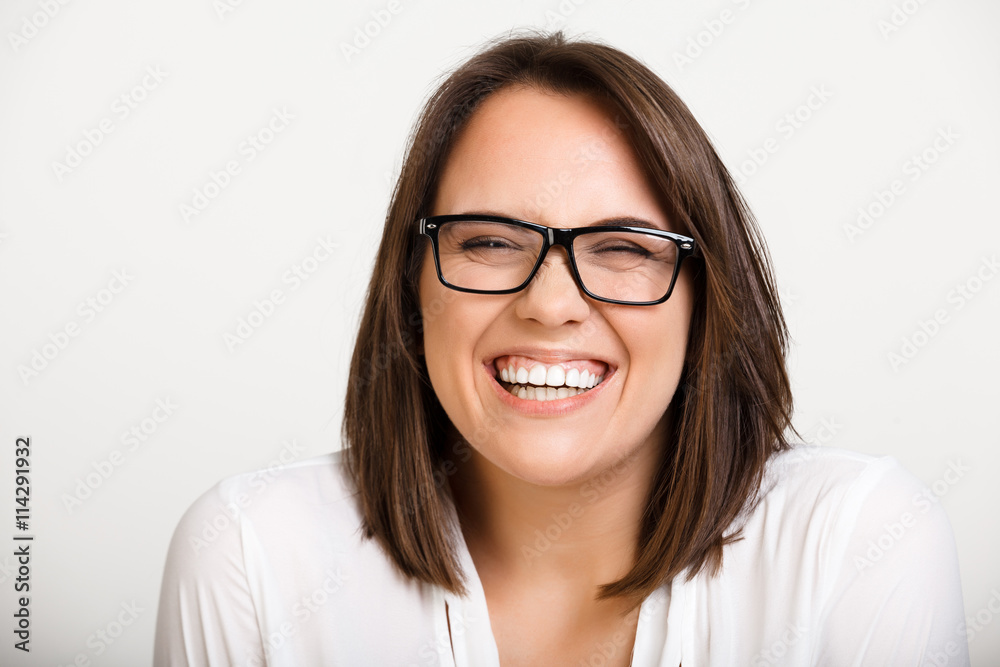 Portrait of girl playing ape over white background.