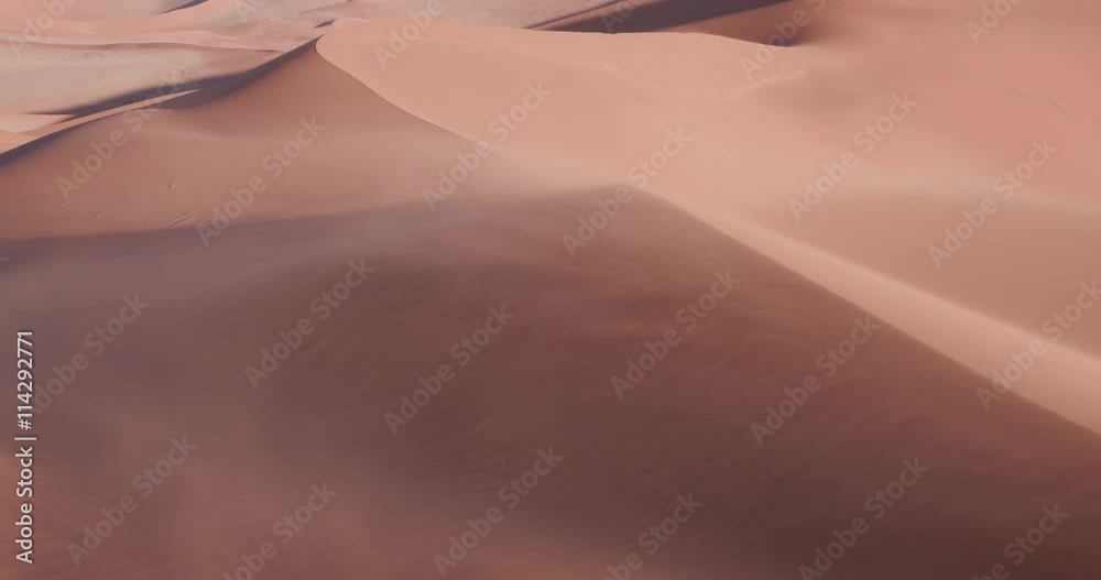 4K static shot of sand blowing over the sand dunes inside the Namib-Naukluft National Park