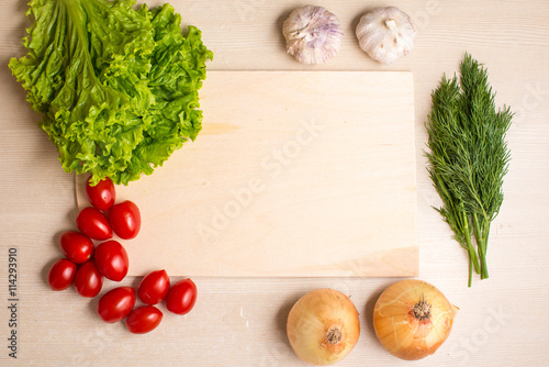Vegetables, chopping board and knife on a table