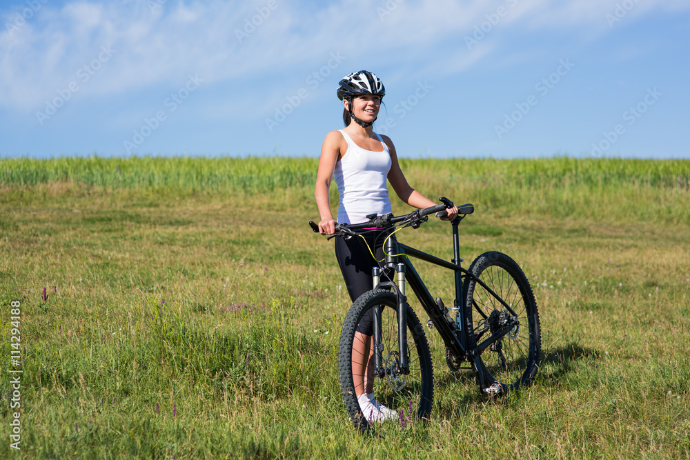 Happy Young Woman riding bicycle outside