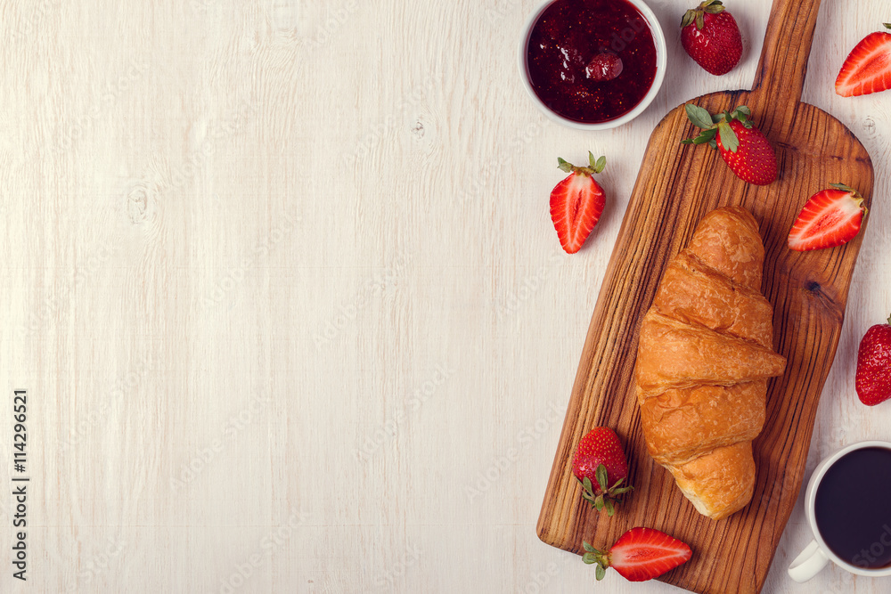 Breakfast with croissant, jam, fruit and coffee. Breakfast with croissant, jam, fruit and coffee.