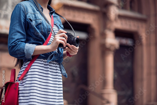 Pleasant woman holding photo camera