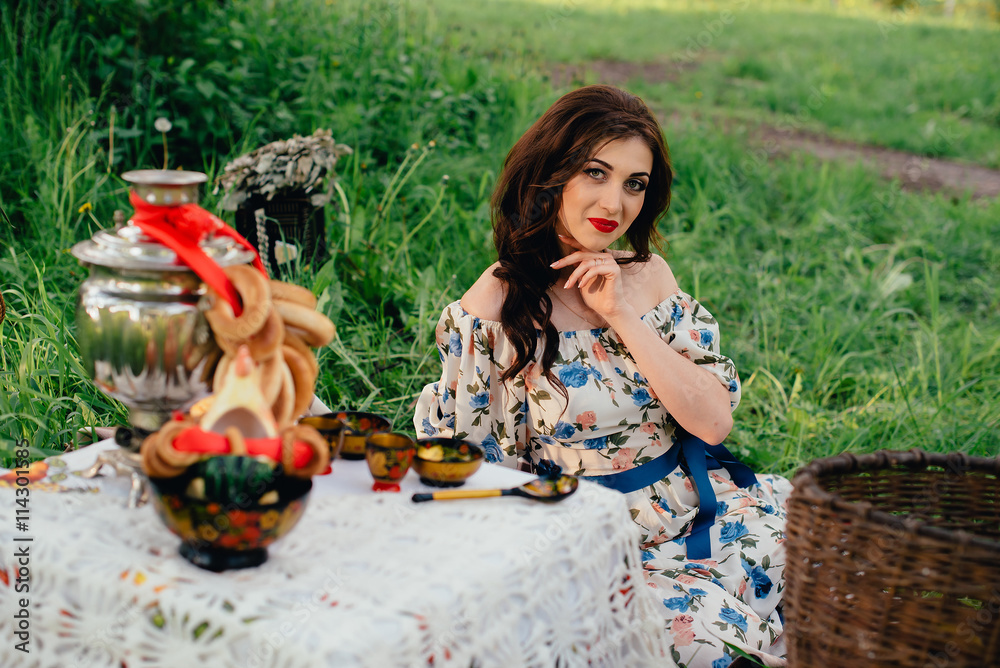 Fototapeta premium Beautiful Russian girl in the decoration on the nature