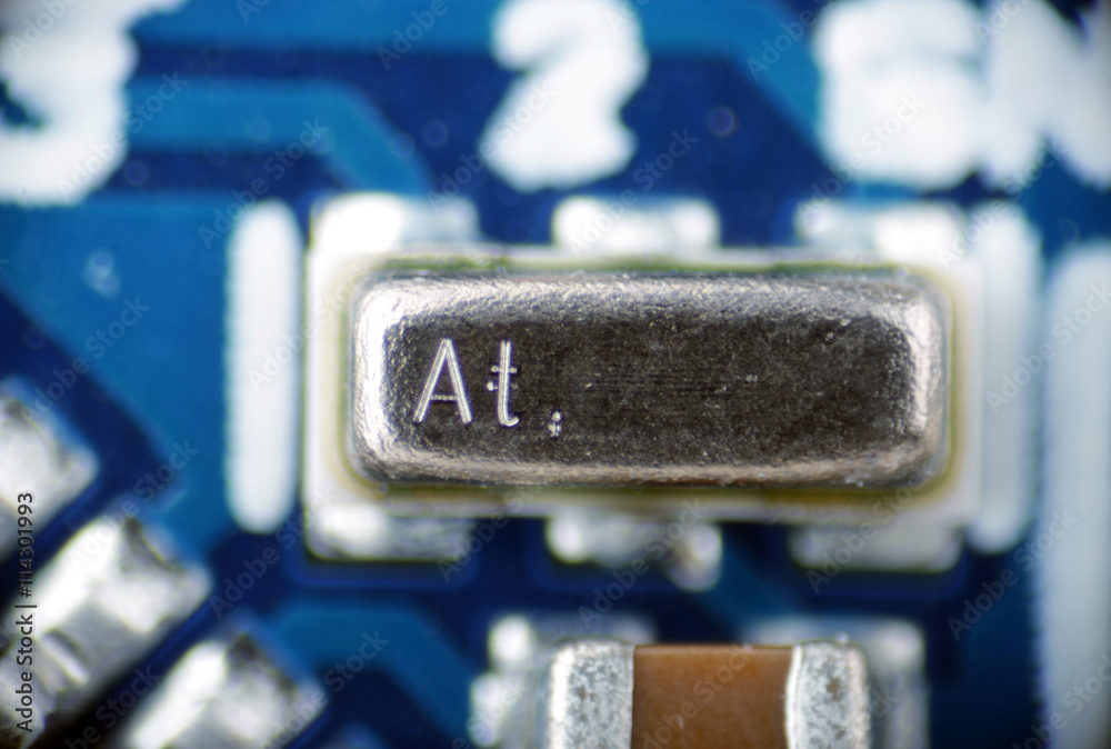 macro photo of a quartz resonator on board pcb macro photo of a quartz resonator on board pcb