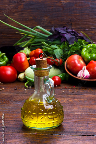 olive oil on vegetables background