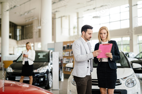 Salesperson working at car dealership