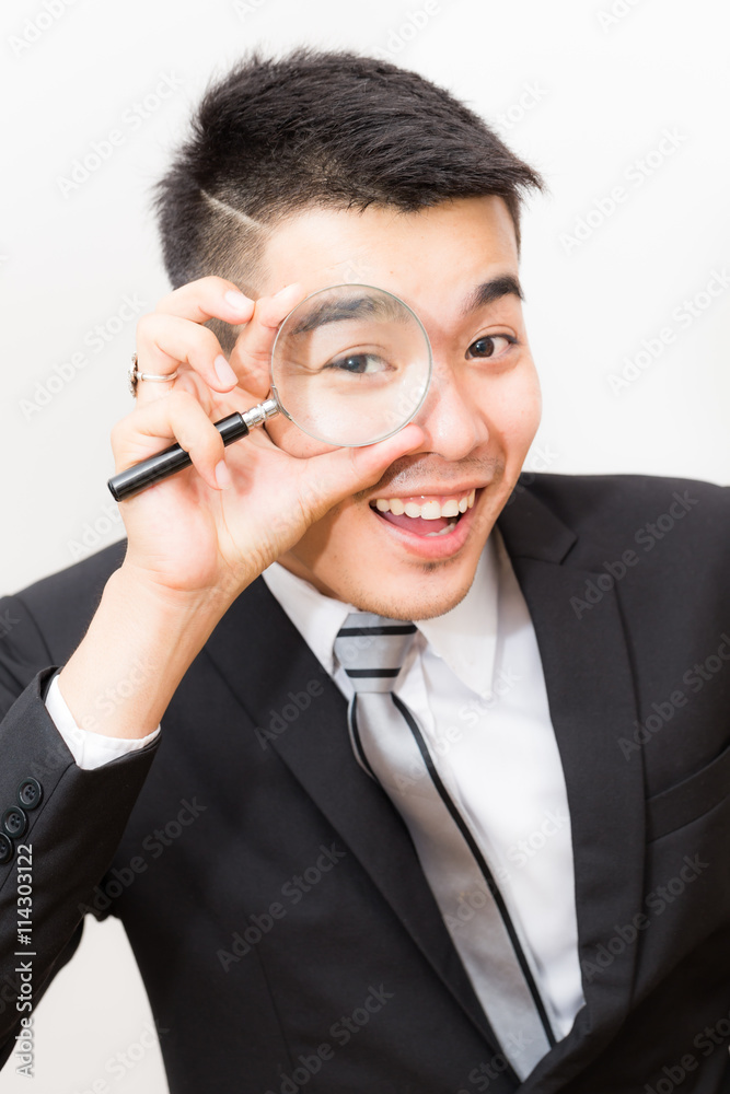 Business asian man Looking At camera Through Magnifying Glass Business asian man Looking At camera Through Magnifying Glass