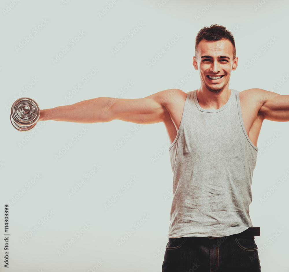 Strong fit man exercising with dumbbells. Strong fit man exercising with dumbbells.
