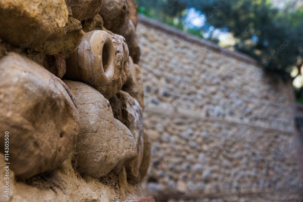 Obraz premium Small drain pipe protruding from a ancient wall. Made in ceramics. Antequera. Andalucia. Spain.