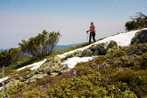 Woman Traveler hiking in the Mountains