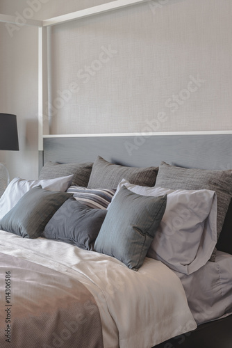 pillows on bed and luxury black lamp style on wooden table side