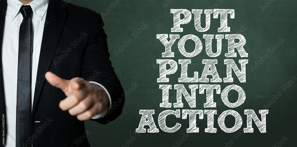 Business man pointing with the text: Put Your Plan Into Action Business man pointing with the text: Put Your Plan Into Action