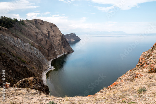 the beauty of lake Baikal , the rocks towering above him on the rocks of the larch grows