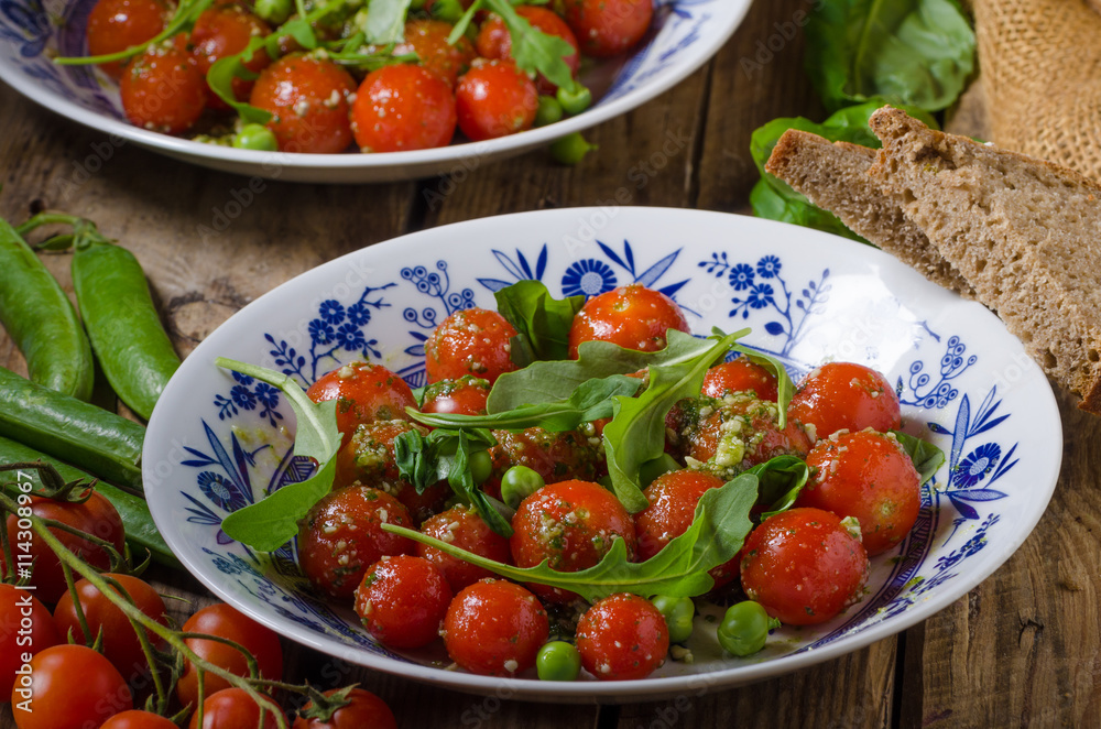 Salad of arugula and cherry tomatoes Salad of arugula and cherry tomatoes