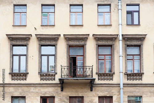 Facade of classic house with windows and a balcony.