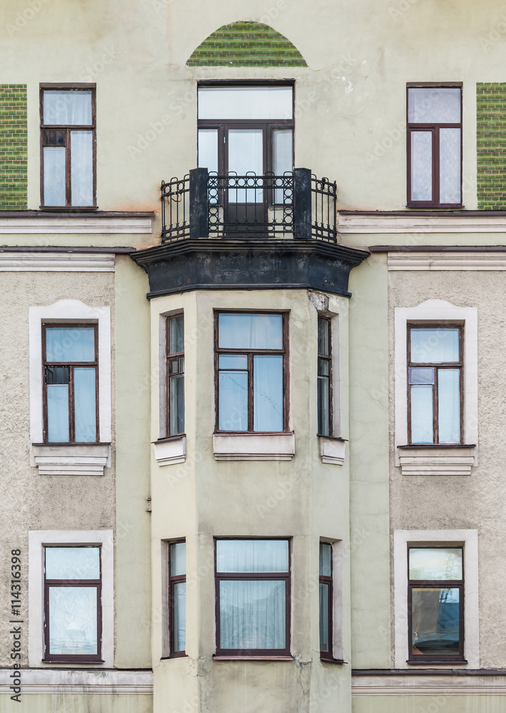 Obraz premium Several windows in a row and bay window on facade of urban apartment building front view, St. Petersburg, Russia.