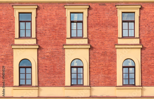 Several windows in a row on facade of urban office building front view  St. Petersburg  Russia.