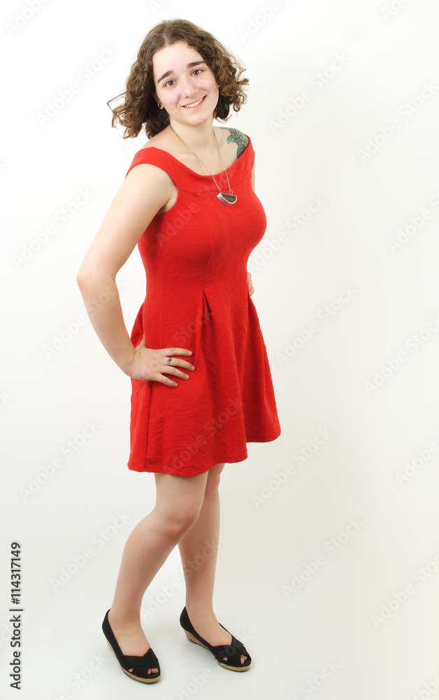 young woman in red dress on white gray background in full length
young woman in red dress on white gray background in full length
