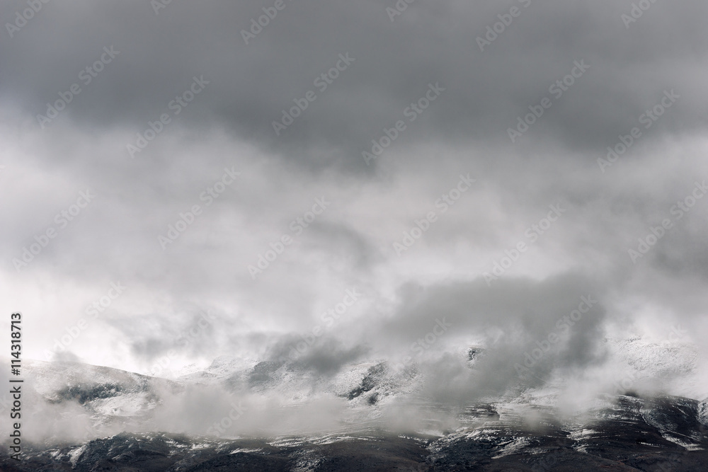 The low clouds over high mountains at winter day