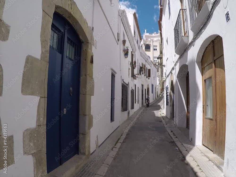 walking down the narrow streets of small Spanish town full of white walls an warm summer weather walking down the narrow streets of small Spanish town full of white walls an warm summer weather