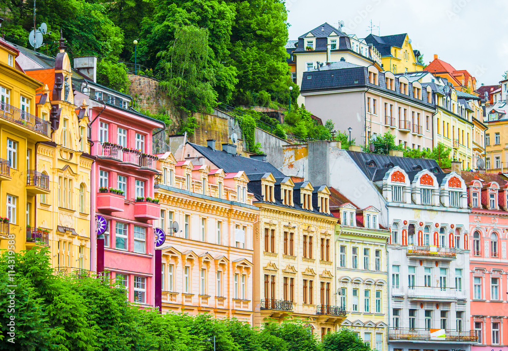 Fototapeta premium Colorful hotels and traditional buildings on sunny town of Karlovy Vary. The most visited spa town in the Czech Republic.