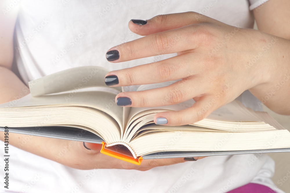 Young girl reading an open book old book. Knowledge, Science. Toned image. Young girl reading an open book old book. Knowledge, Science. Toned image.