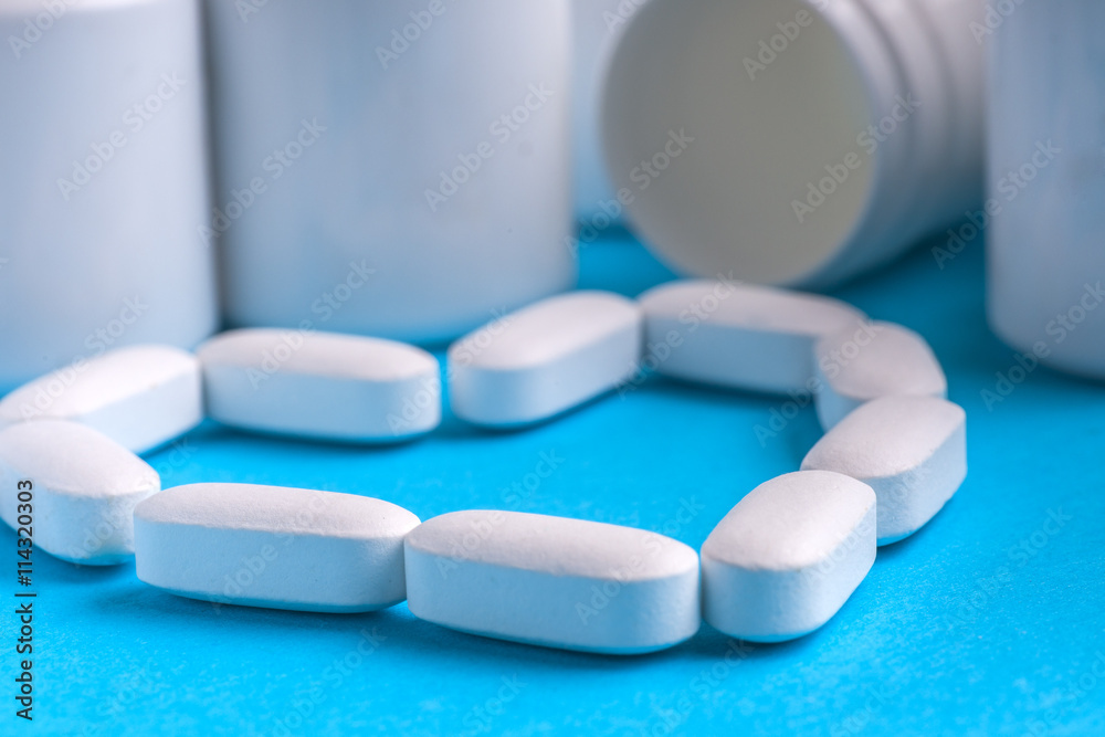 Many pills and tablets isolated on light blue background Many pills and tablets isolated on light blue background