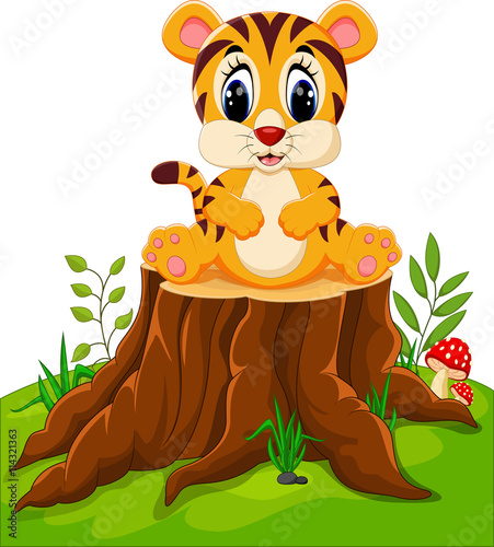 Fototapeta Naklejka Na Ścianę i Meble -  Cute baby tiger sitting on tree stump