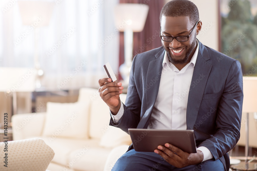 Man holding bank card and tablet Man holding bank card and tablet