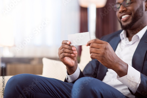 Afro American man holding blank baseness card photo