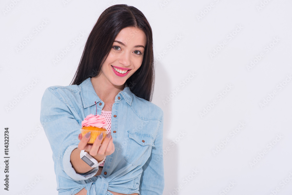 Overjoyed smiling woman holding cupcake Overjoyed smiling woman holding cupcake