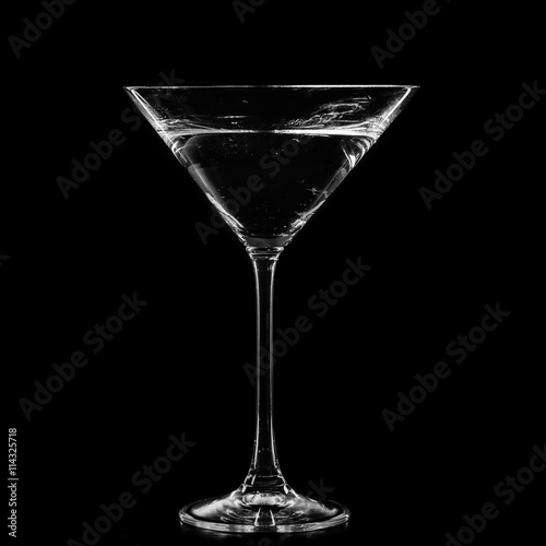 Martini in a cocktail glass isolated on black background