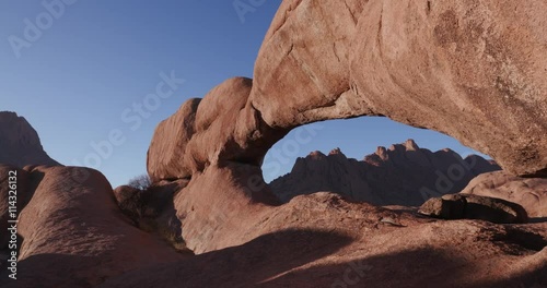 4K panning shot of the famous rock arch of the Spitzkoppe mountains photo