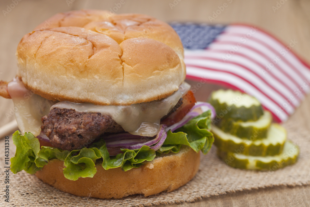 American grilled hamburger with USA flag. 4th of July. Independence day. American grilled hamburger with USA flag. 4th of July. Independence day.