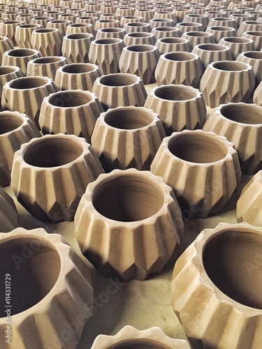 Unfinished clay pots wait for burning process in pottery industry.