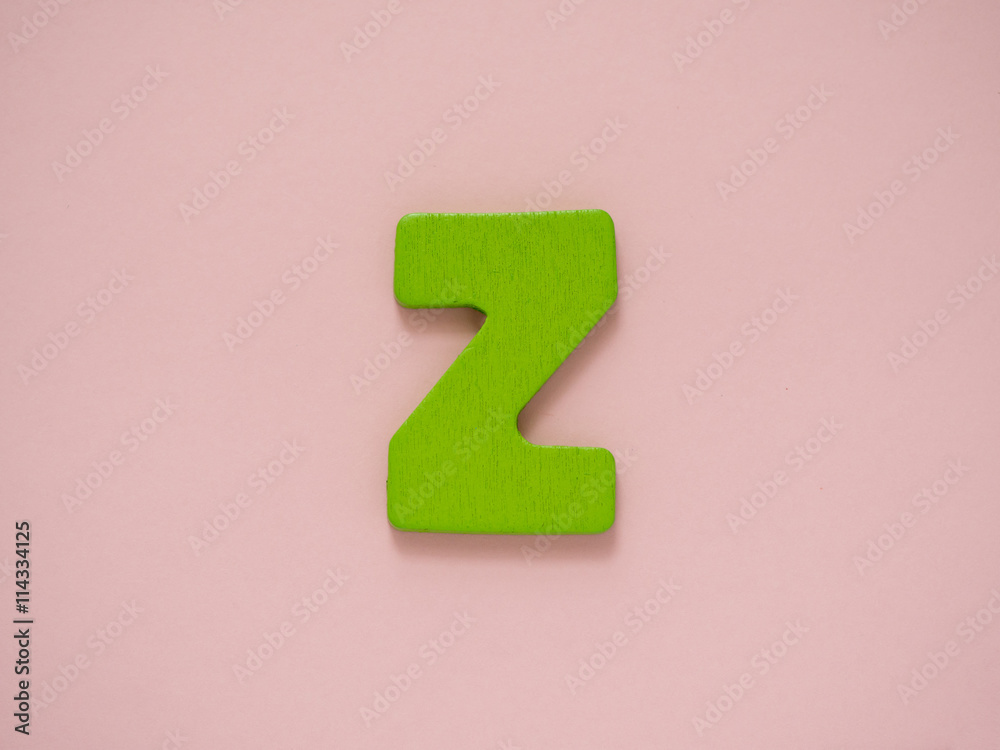 Capital letter Z. Green letter Z from wood on pink background.