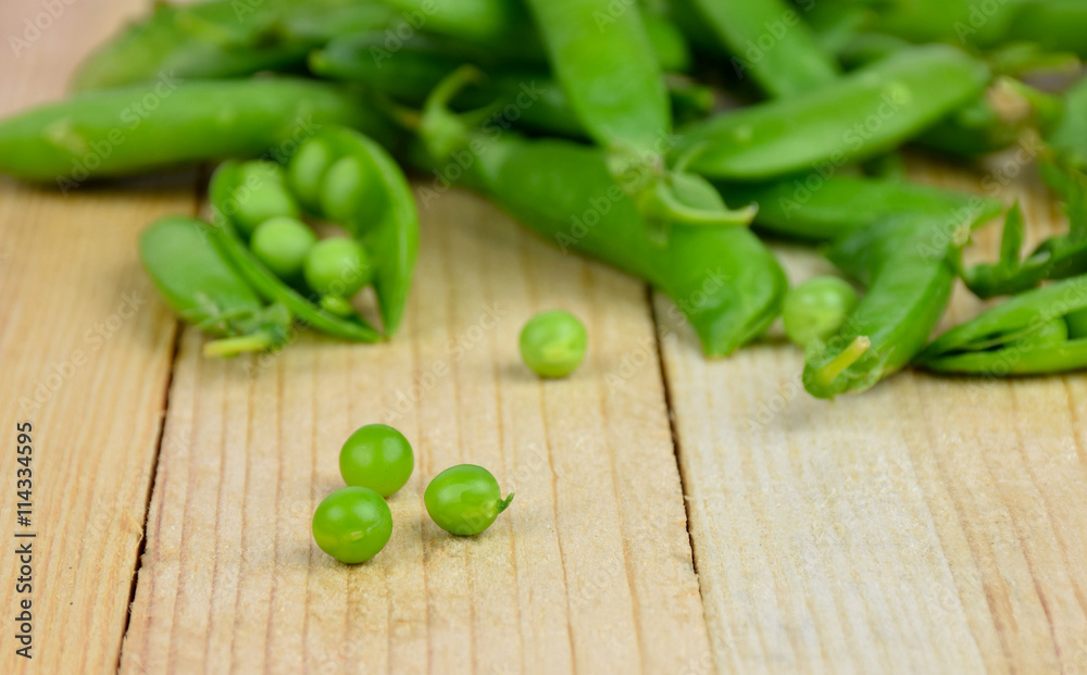 Pods of green peas close-up on wooden background. Pods of green peas close-up on wooden background.